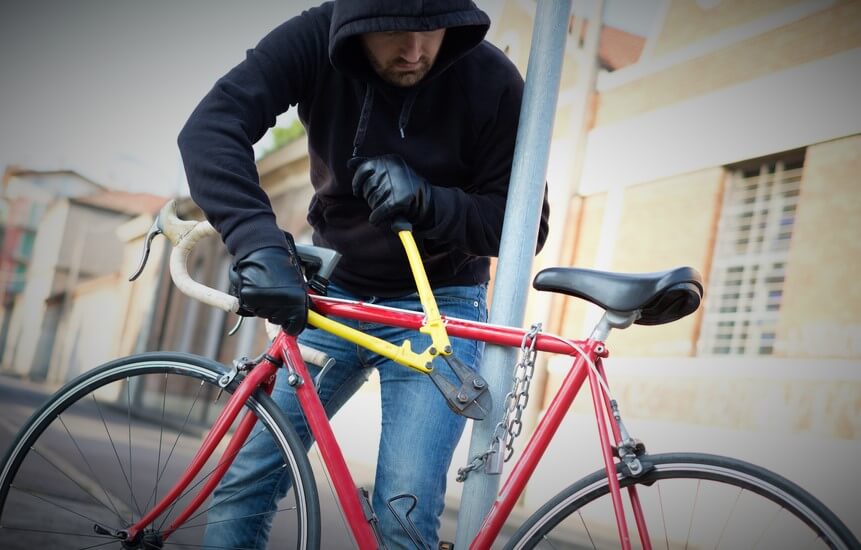 Bike thief stealing a locked bike