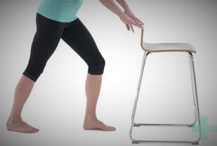 Leg stretch using a chair for support